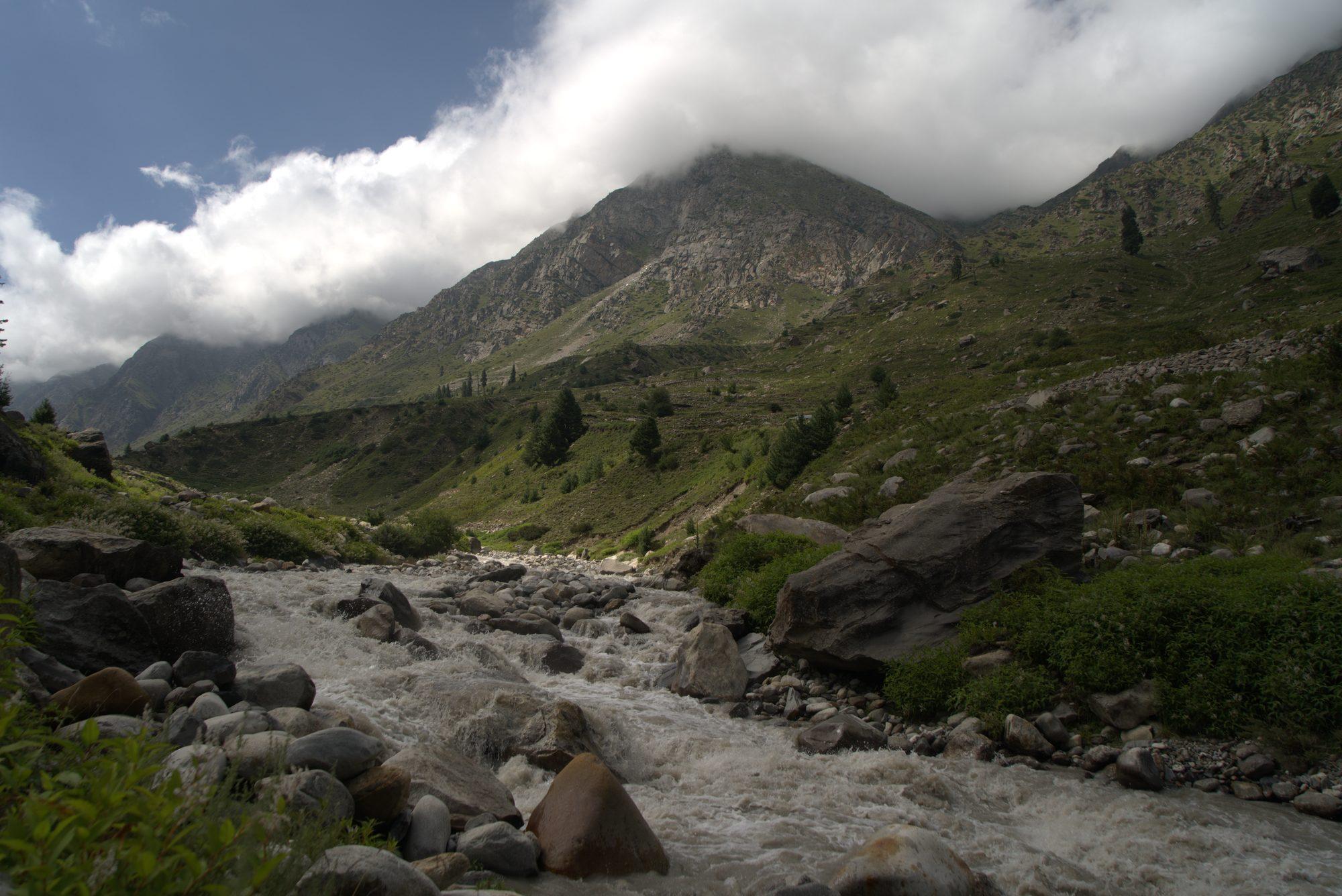 Prayer flags strung above the valley with the Kinnaur snow range beyond