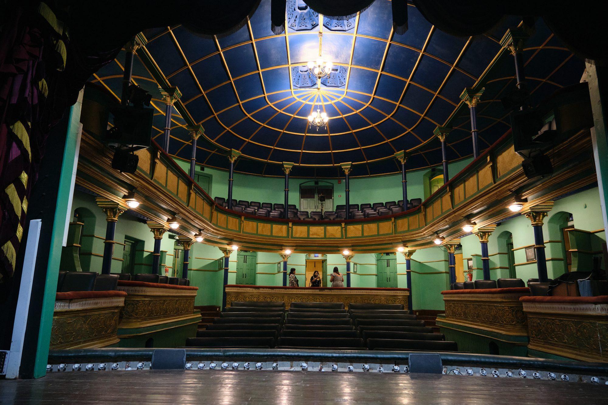 The auditorium from the stage, green tiers rising to the gilt ceiling