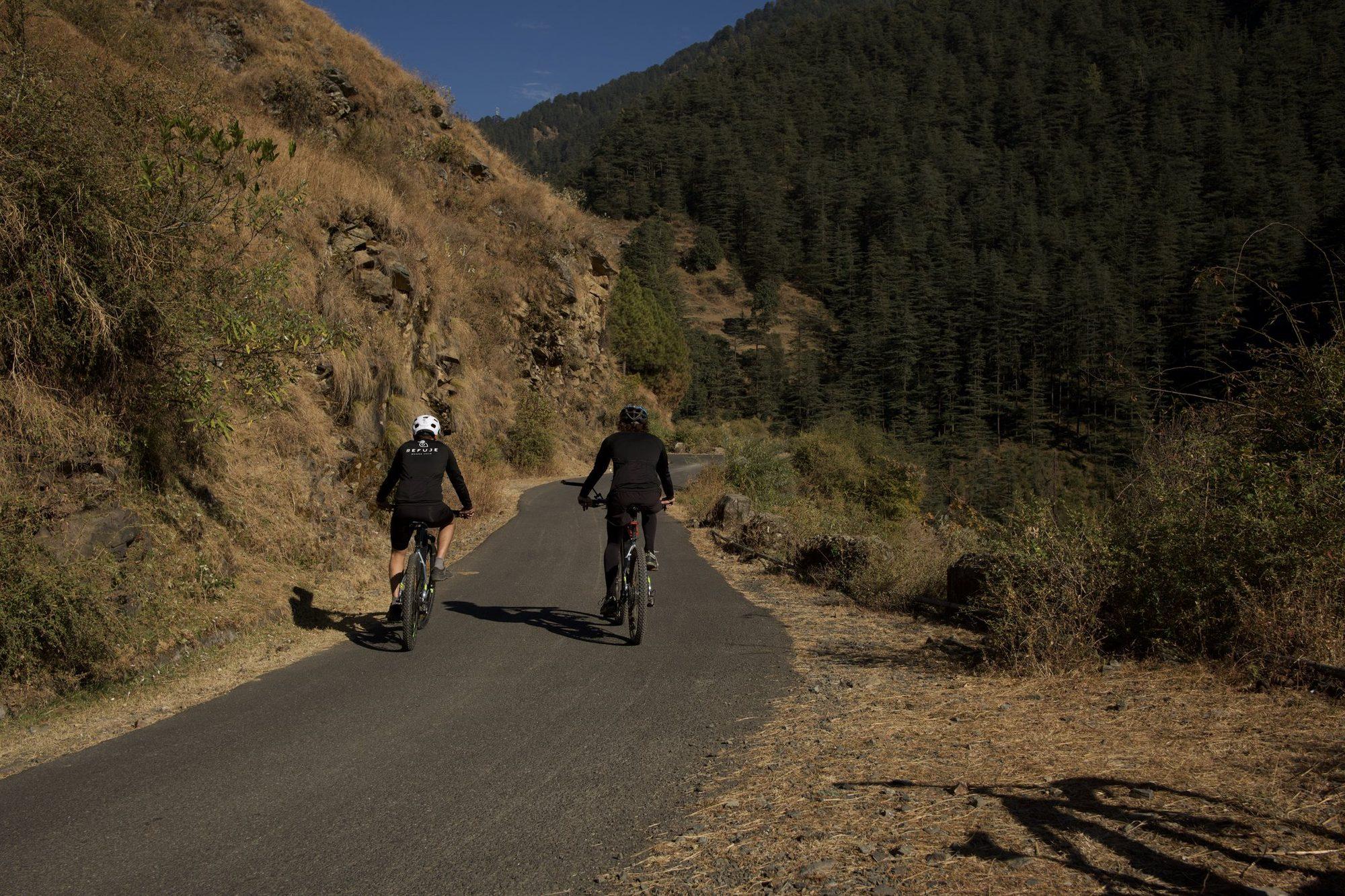 Two riders climbing the paved country road