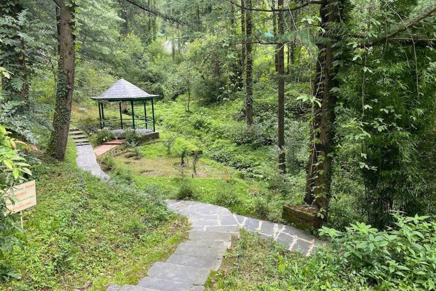 A garden pavilion beside the paved path through the Glen