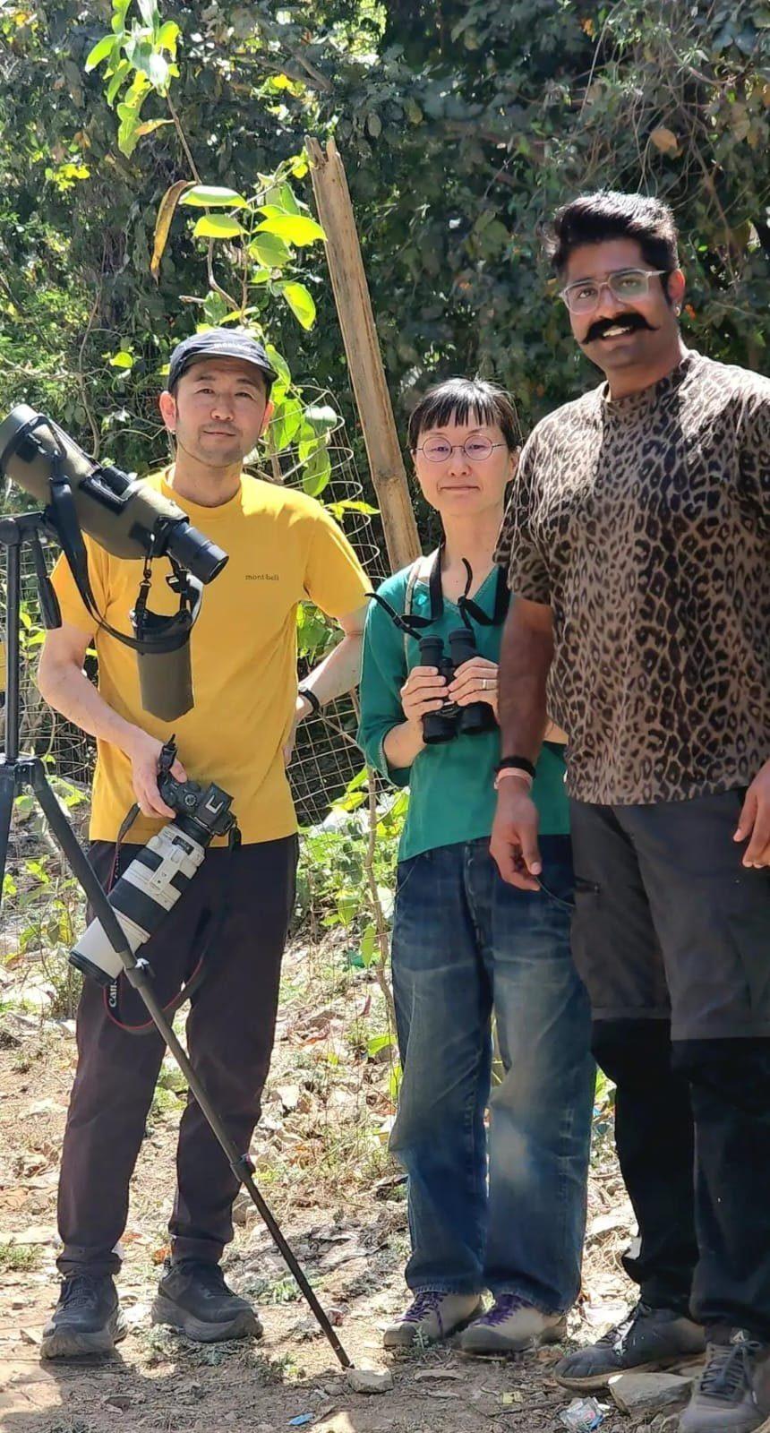 Birders on the trail with camera and binoculars
