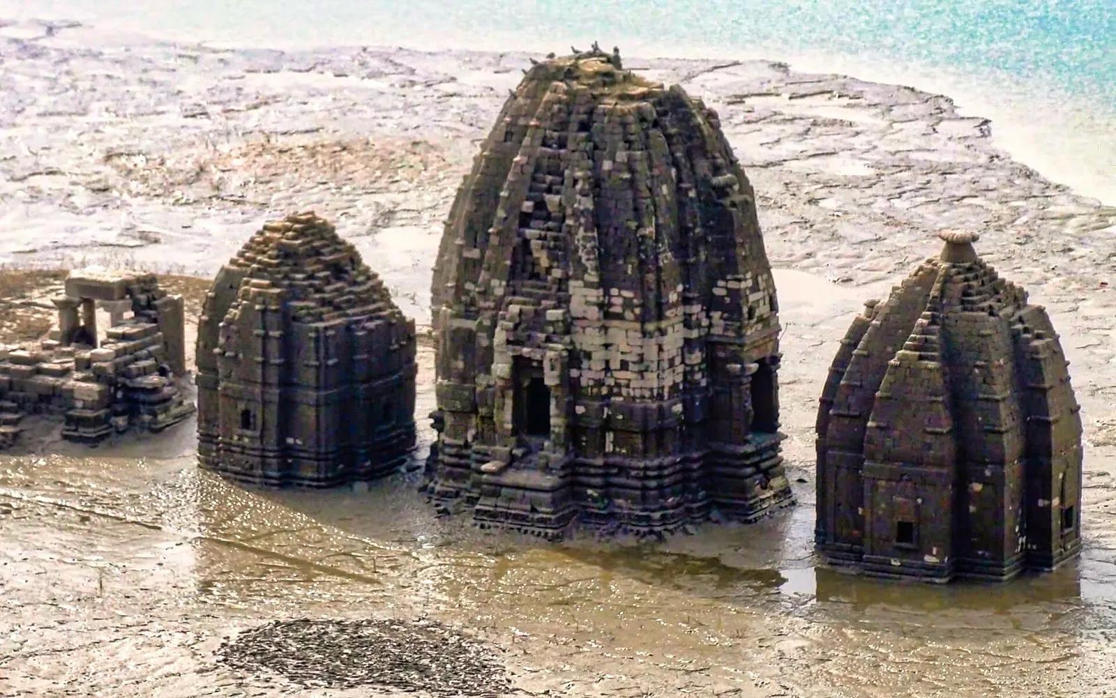 Shikhara towers of old Bilaspur's submerged temples standing in the drying bed of Gobind Sagar reservoir, Himachal Pradesh