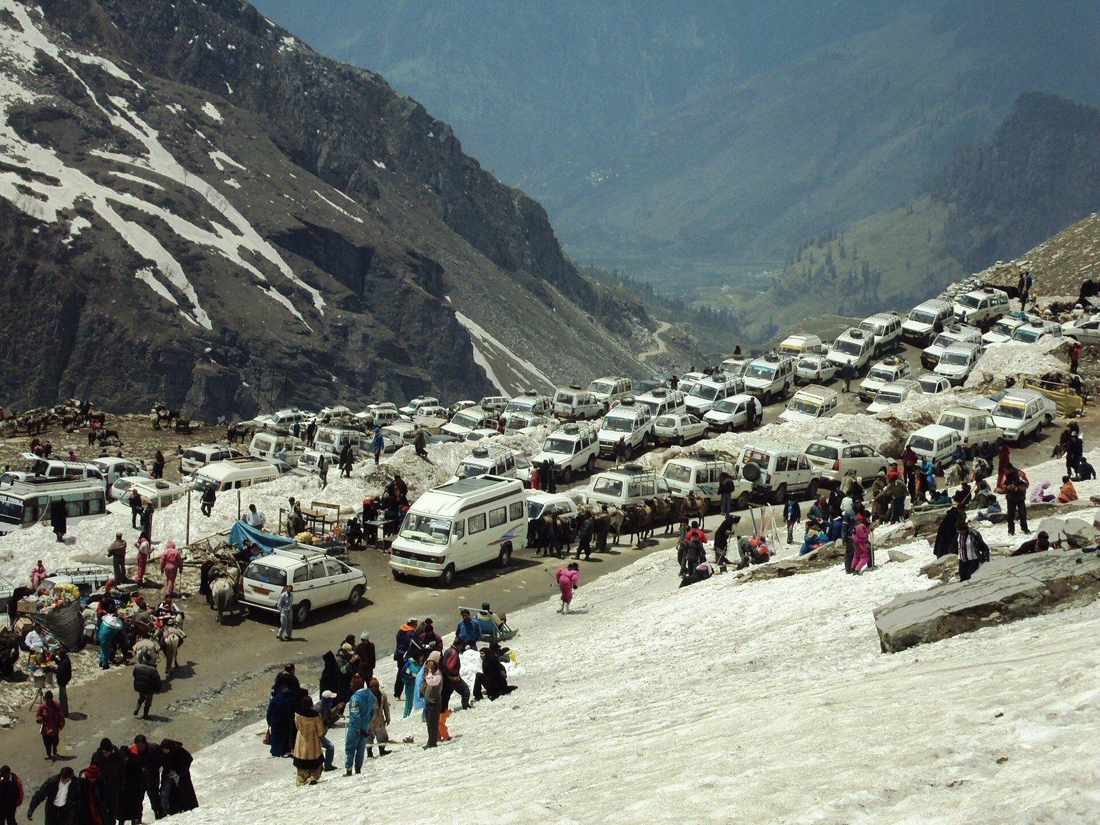 Hundreds of tourist vehicles parked on snow at Rohtang Pass in Himachal Pradesh, the pass that requires a daily permit and has a 1200-vehicle limit