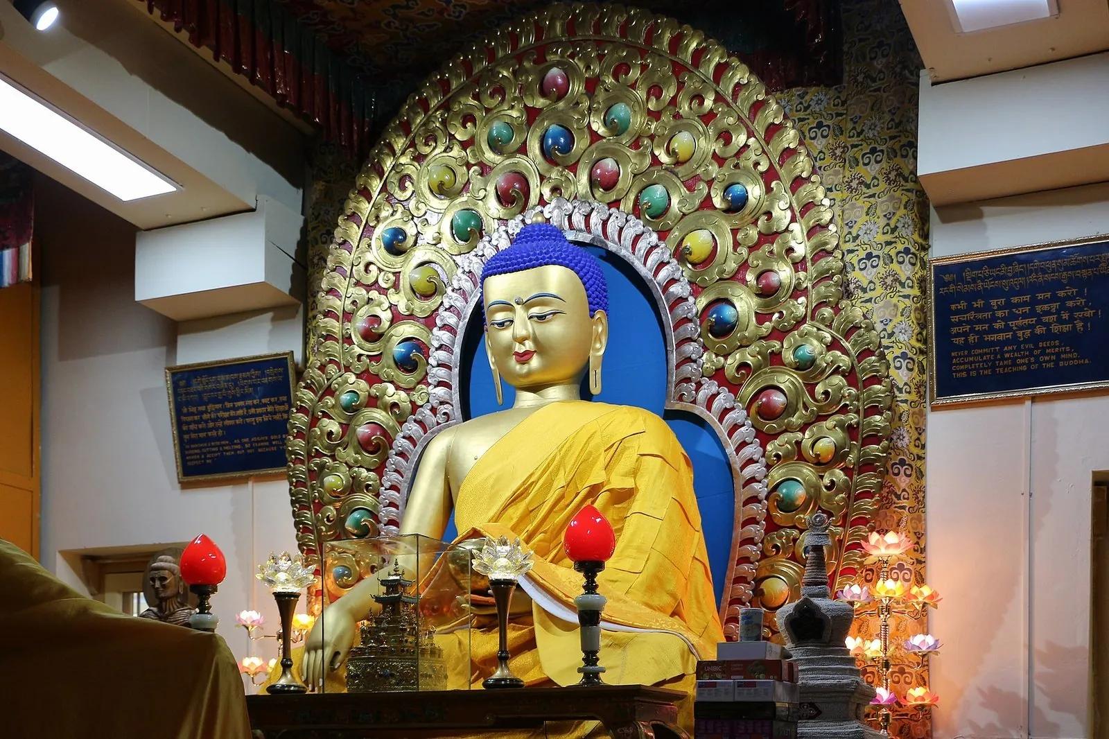 Large gilded seated Buddha statue inside the Tsuglagkhang main shrine, McLeod Ganj, Dharamshala