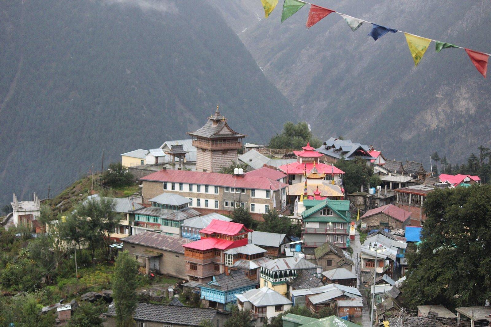 Kalpa village in Kinnaur with prayer flags and traditional temple tower against the deep Sutlej valley