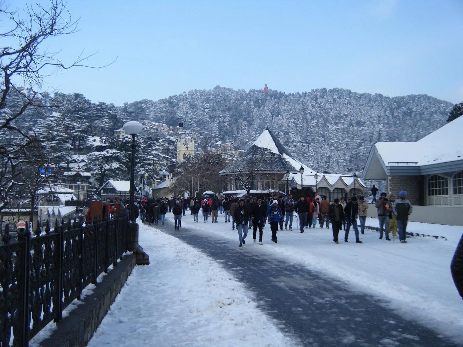 The Ridge in Shimla under fresh winter snow with crowds walking past Christ Church, the hub for ten day trips around the city