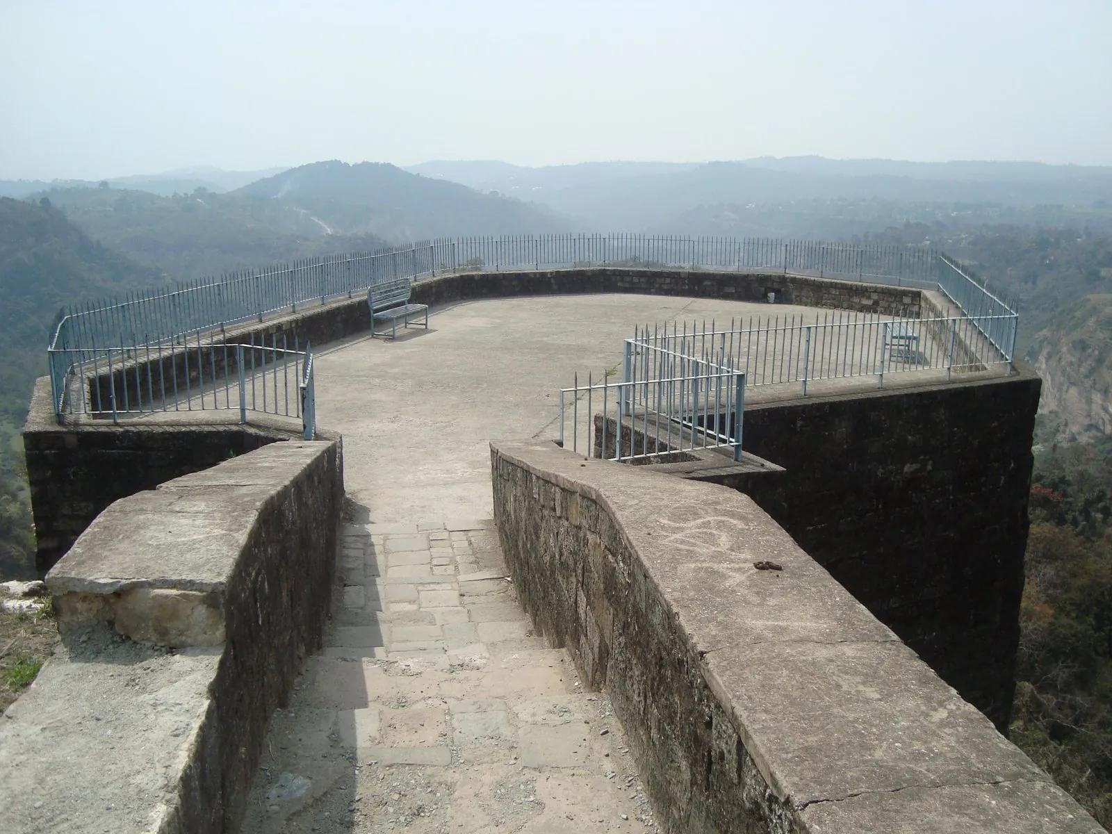 The top rampart of Kangra Fort with the Banganga gorge curving below and the Dhauladhar foothills hazing into the distance