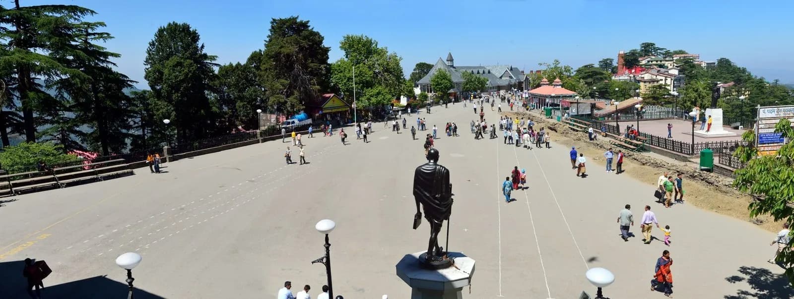 The Ridge in Shimla — a long open promenade with the bronze Gandhi statue and deodars beside the colonial roofs of Town Hall and Mall Road, where Indian Coffee House and Wake & Bake sit
