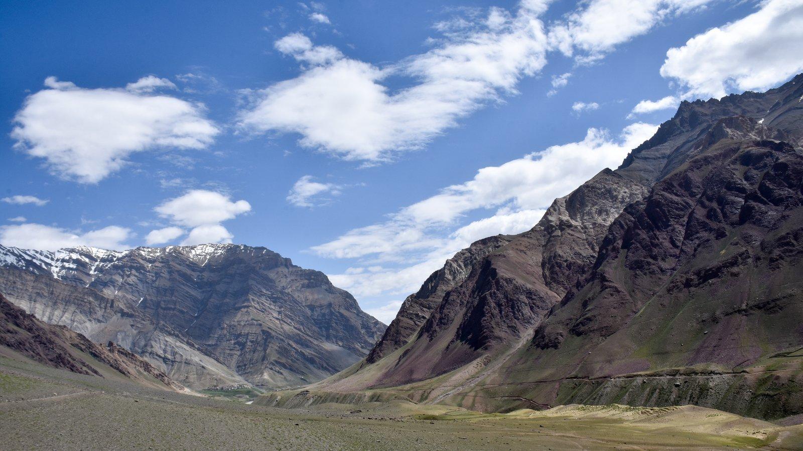 Pin Valley in Spiti — wide brown desert valley with snow-capped Himalayan peaks and clouds, classic high-altitude cold desert landscape