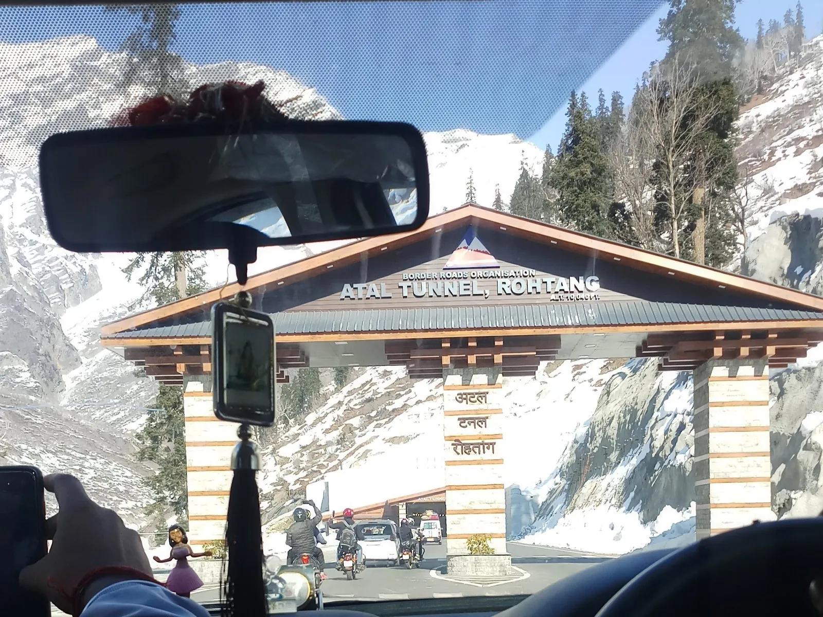 Atal Tunnel south portal entrance near Manali with BRO signage in English, Hindi and Tibetan, snow on surrounding mountains