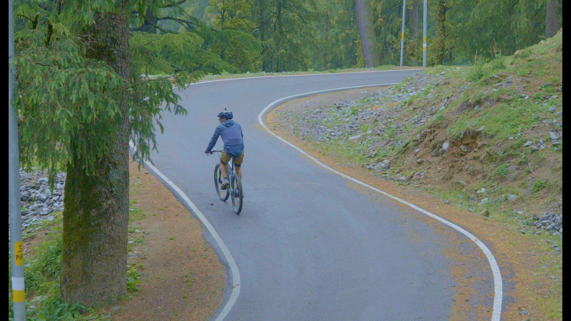 Cyclists on a misty apple-belt road on the Golden Belt route