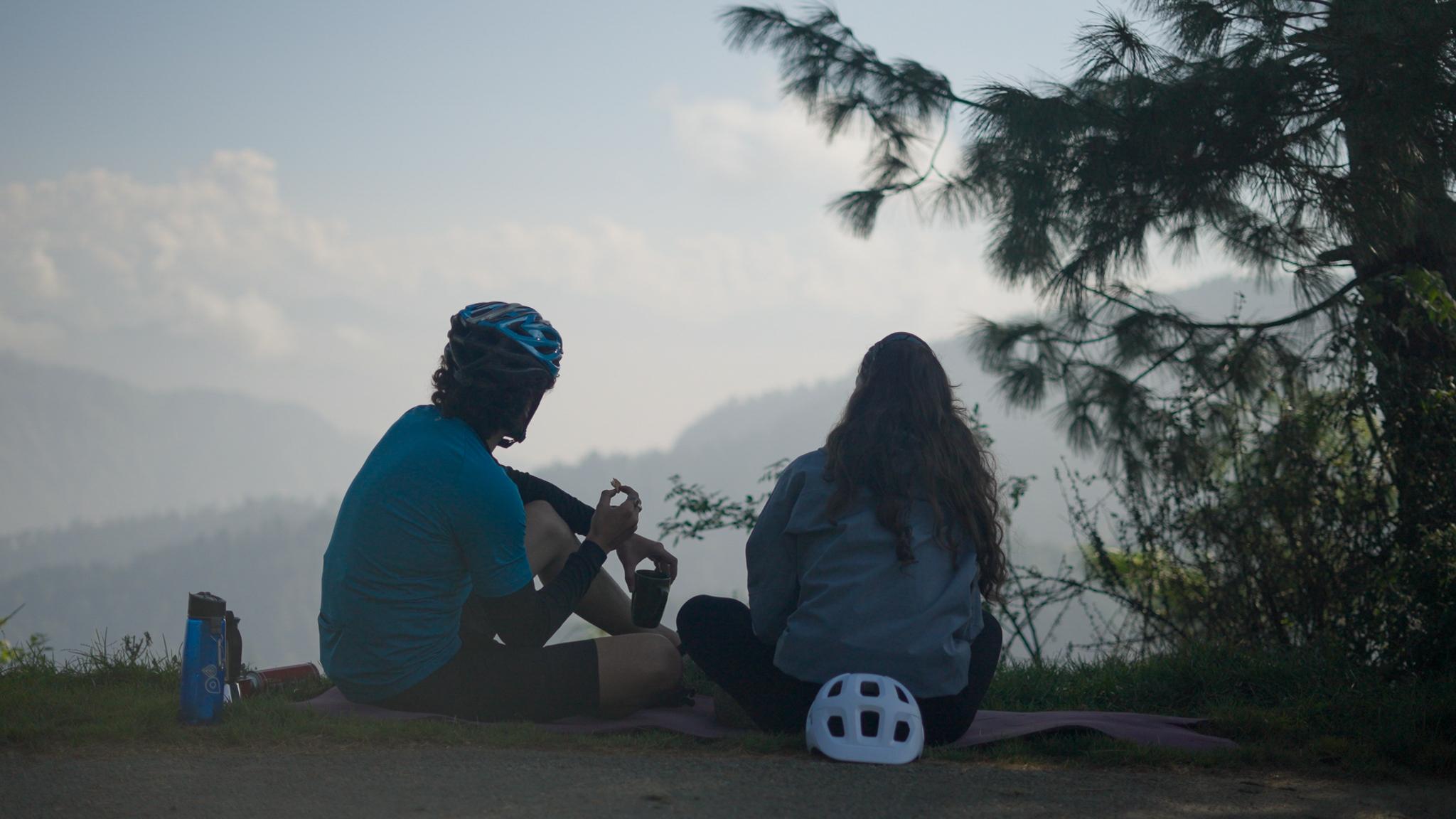 Two riders pausing together to take in the mountain view