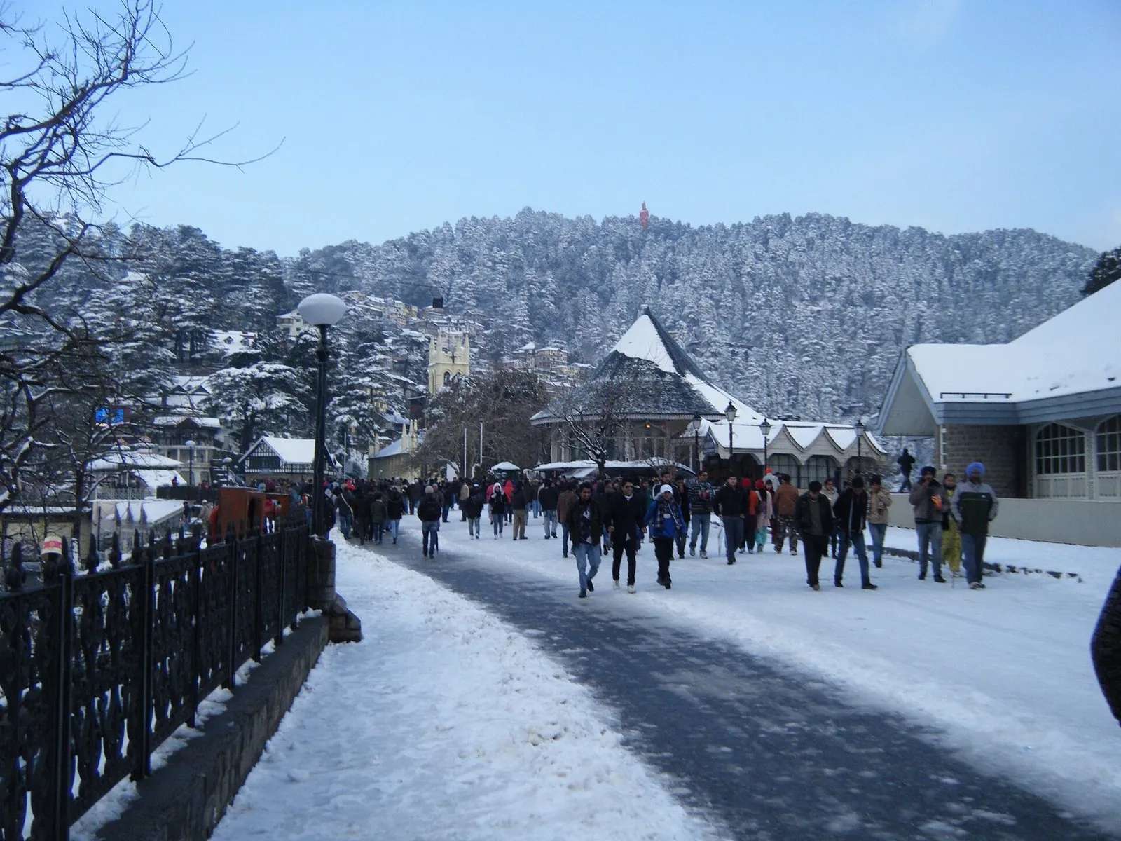 The Ridge in Shimla under fresh winter snow with crowds walking past Christ Church, the hub for ten day trips around the city