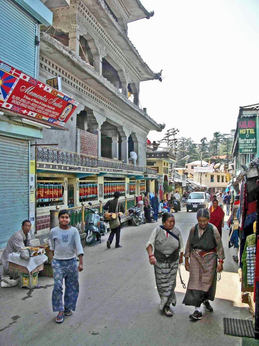 Main street in McLeod Ganj with Tibetan shops, prayer wheels and locals walking