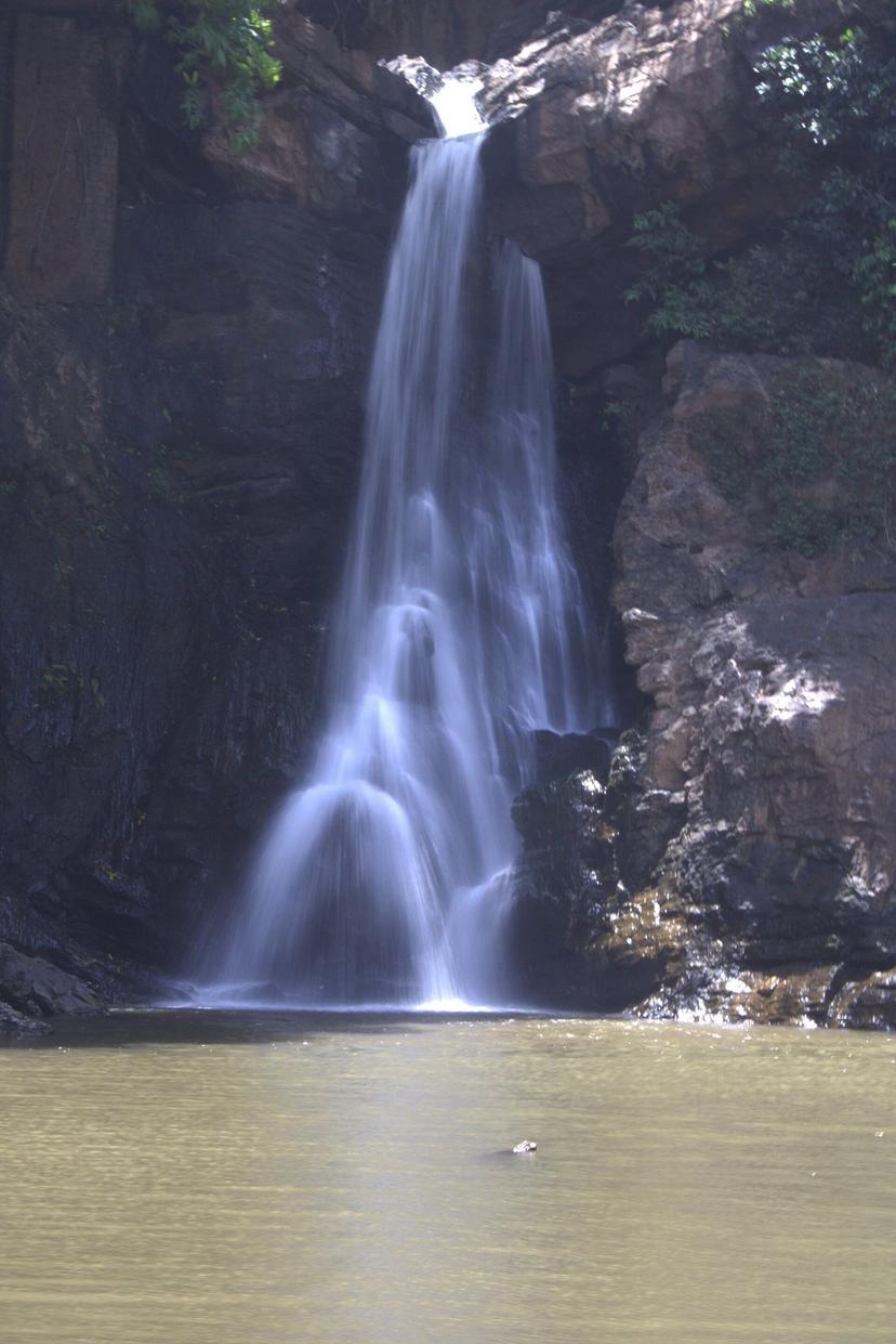 The Arvalem waterfall dropping down a rock face into a green pool