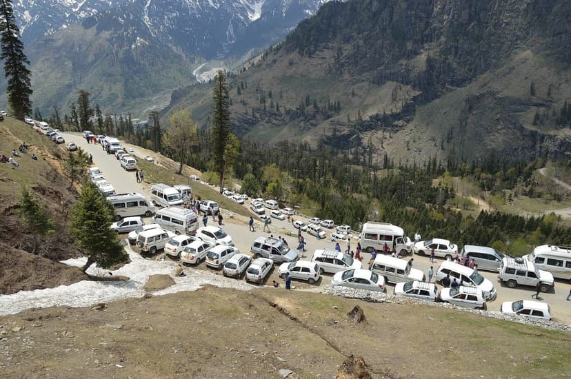 Dozens of white taxis and tourist vans jammed on the switchbacks at Gulaba on the Manali to Rohtang highway with the Beas valley behind