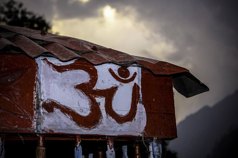 Kheerganga mountain shrine with painted Om symbol on wooden structure Parvati Valley spiritual site