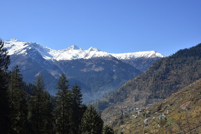 Tosh village on a forested hillside, snow peaks above, view from the Kutla trail
