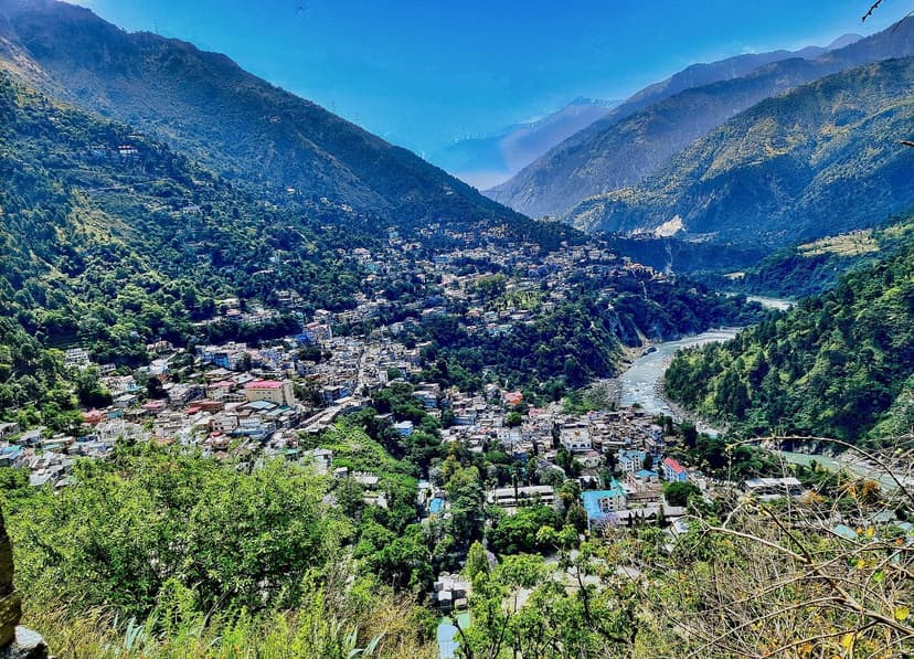 Chamba town filling a green valley along the Ravi river with mountain ridges rising on both sides, Himachal Pradesh