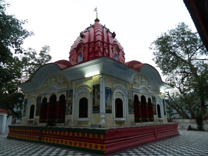 Tarna Devi temple in Mandi with a red domed roof, white arched mandap and a checkerboard stone floor