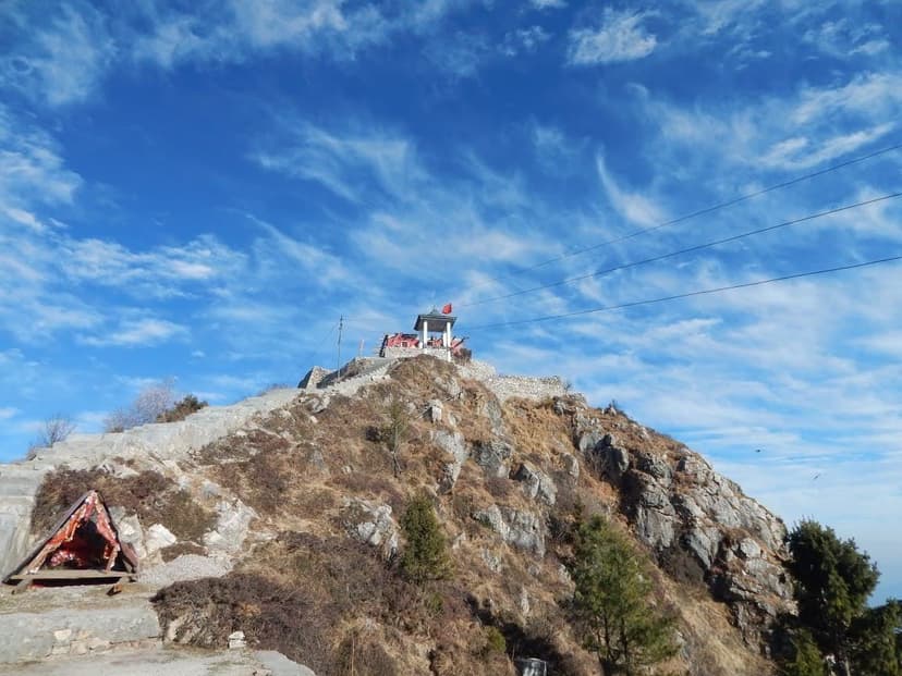 The small Shali Mata temple on the rocky summit of Shali Tibba against a deep blue sky