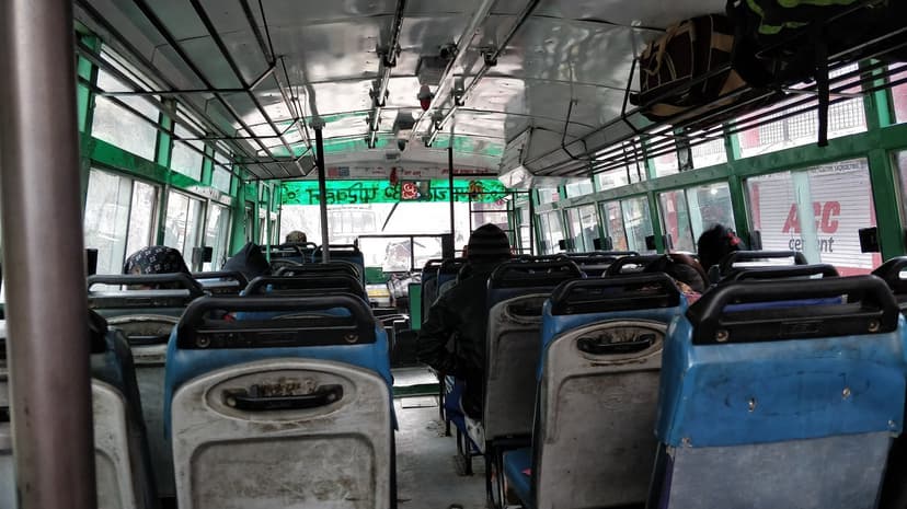 Interior of a non-AC HRTC Ordinary bus showing faded plastic bench seats, the cheapest rural service at the opposite end of the spectrum from the Himsuta Volvo