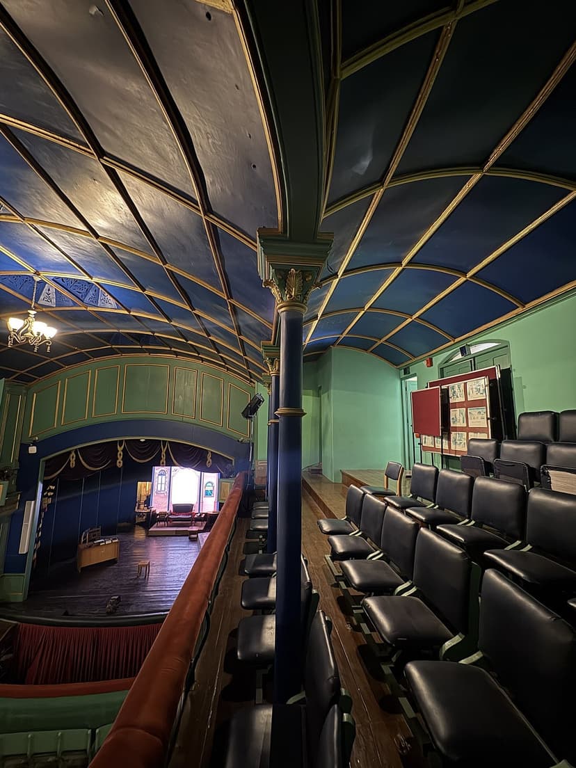The ornate blue and gold painted vaulted ceiling and cast-iron pillar of the Gaiety Theatre interior in Shimla