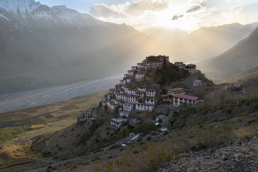 Key Monastery in Spiti at sunrise — whitewashed Tibetan Buddhist monastery built in fortress style on a cliff above the Spiti river