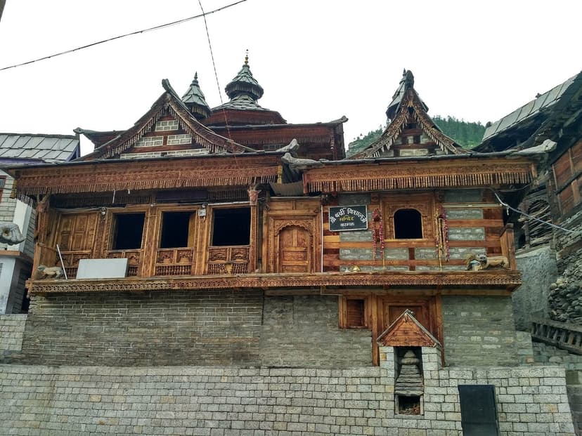 Shri Badri Vishal Temple at Kamru Fort near Sangla in Kinnaur — ancient wooden fort-temple with ornate kath-kuni facade showing carved deodar panels and stone base layers