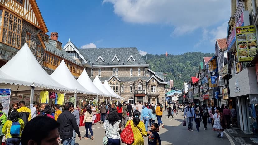 Gaiety Theatre Shimla with grey stone Gothic Victorian facade, half-timbered Tudor buildings alongside, pedestrians on the walking-only Mall Road