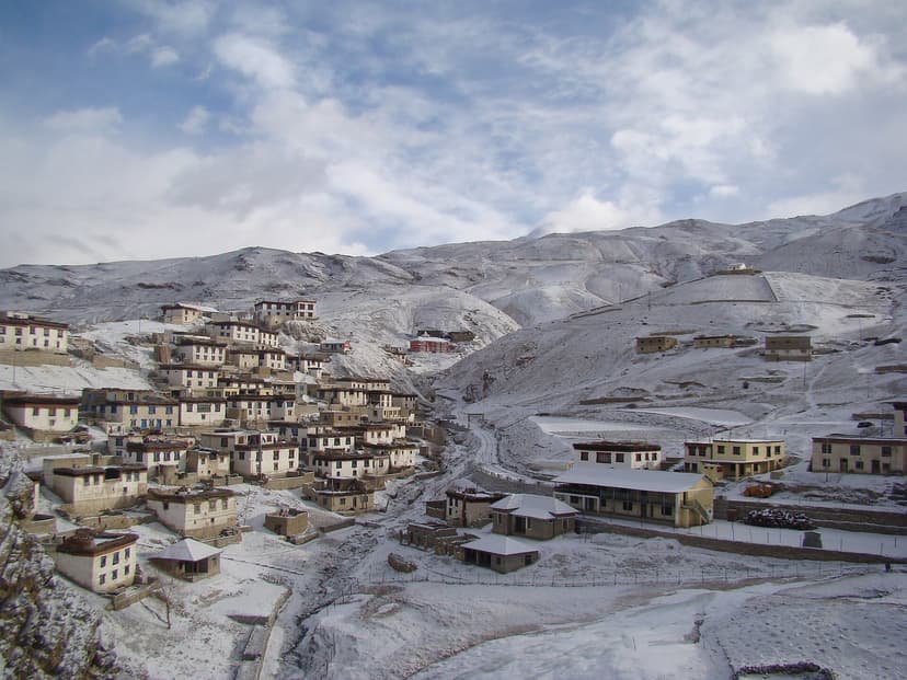 Whitewashed stone-and-mud houses of Kibber village in Spiti Valley clinging to a snow-dusted slope at 4,270 metres