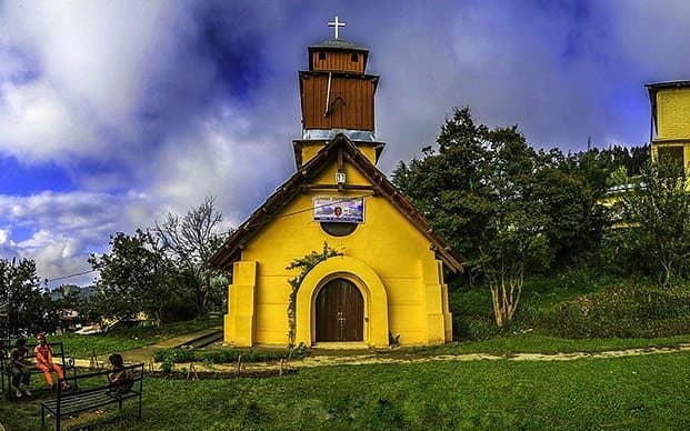 Historic church building in Kotgarh surrounded by apple orchards