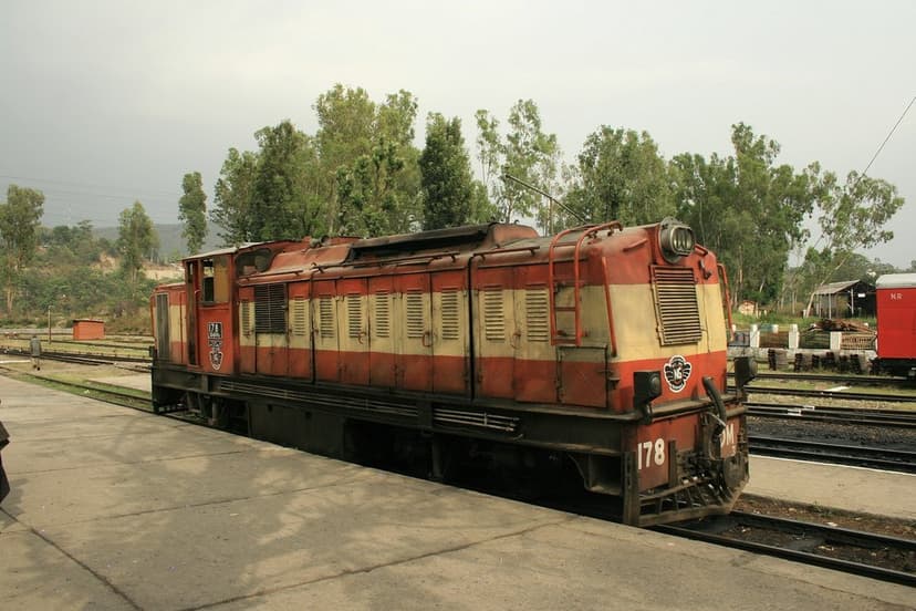 A red and cream ZDM-class narrow-gauge diesel locomotive number 178 standing on the tracks at a Kangra Valley Railway yard