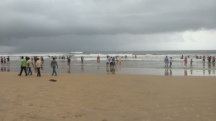 Rough brown Arabian Sea and dark storm clouds at Baga during Goa's monsoon