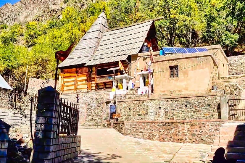 Mrikula Devi Temple at Udaipur in Lahaul — a 6th-century wooden temple with stone walls and metal-and-slate roof, known for extraordinary wood carvings inside