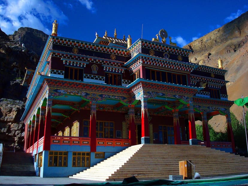 Sakya Tangyud monastery in Kaza, Spiti, with red and ochre painted facade and prayer wheels