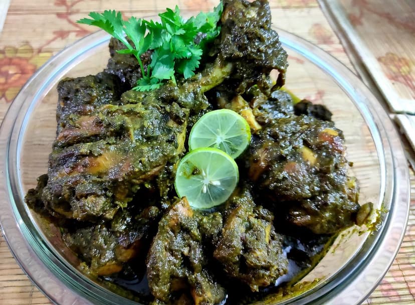 Chicken cafreal, pieces of chicken coated in a dark green coriander-and-chilli masala, garnished with coriander and lime