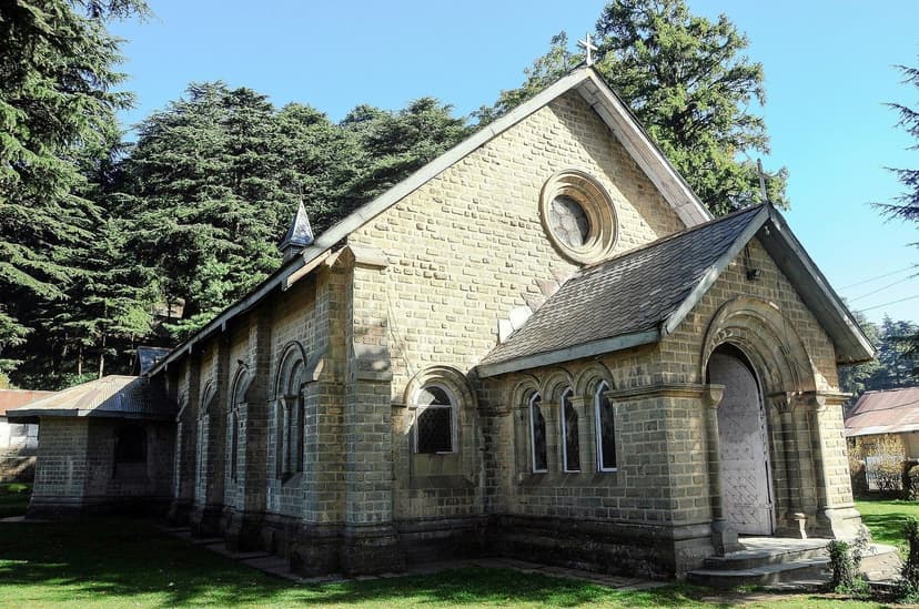 St. John's Church Dalhousie, grey stone Protestant church built in 1863 with rose window, surrounded by deodar trees