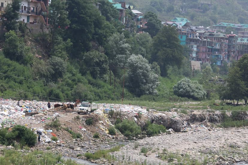 A town's garbage dumped along the bank of a Himalayan river in Himachal Pradesh