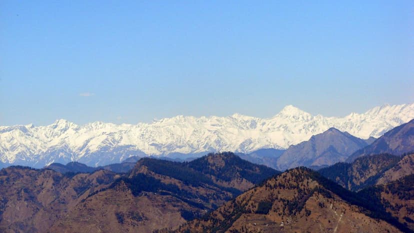 Snow-capped Himalayan peaks stretching across the horizon as seen from Jalori Pass, Kullu district